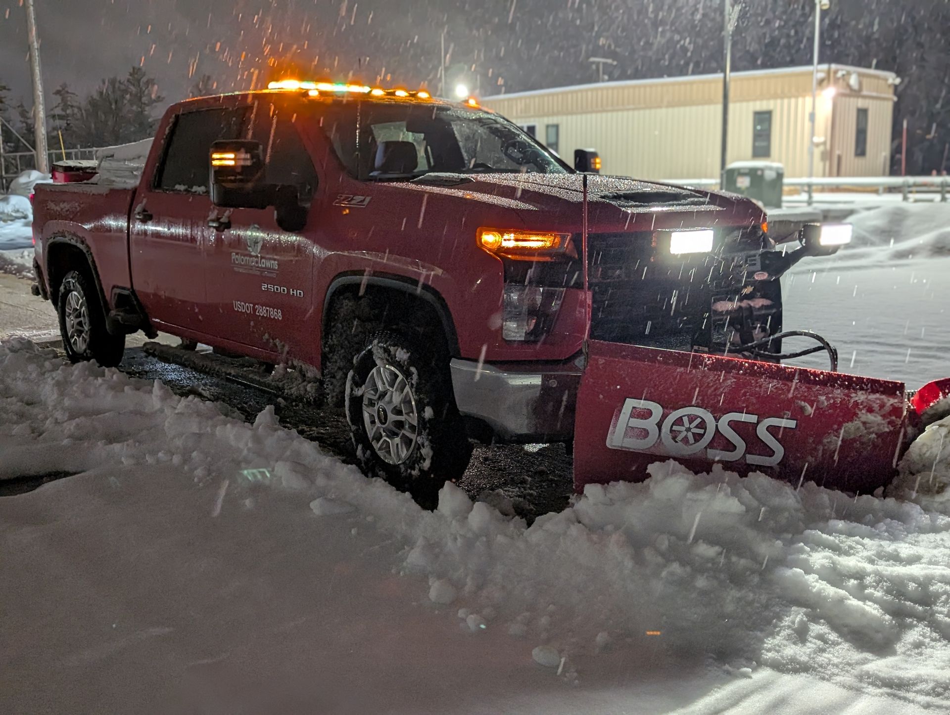 A truck plowing through snow.