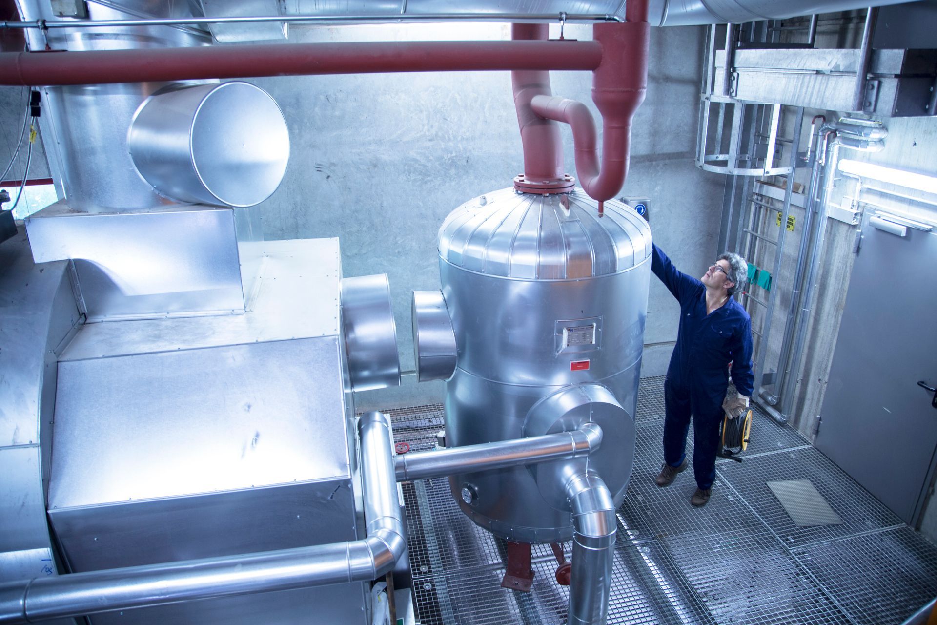 engineer inspecting boiler