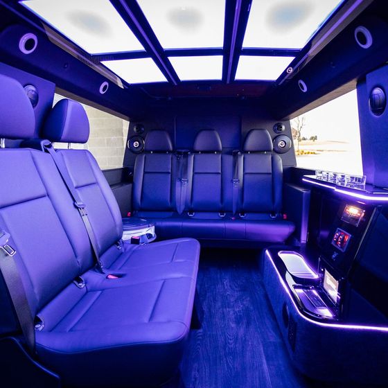 The inside of a van with purple seats and a blue ceiling