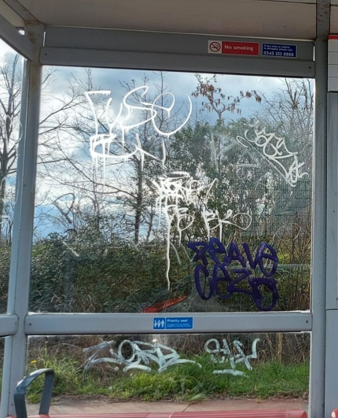 Acid etch graffiti on London bus shelters