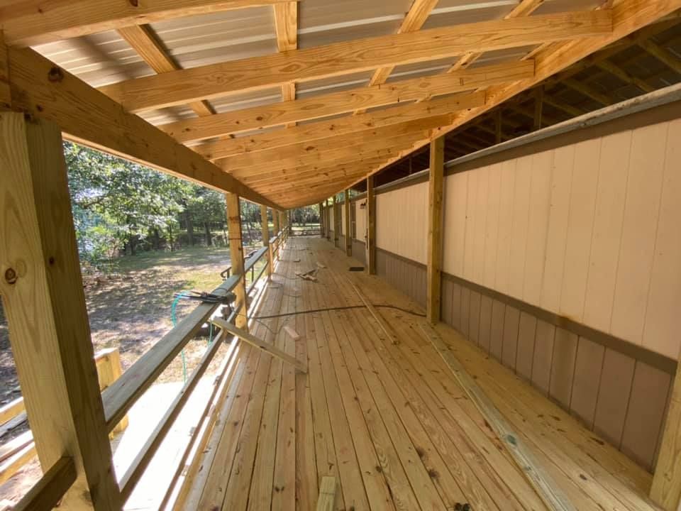 A long wooden walkway with a metal roof is under construction.