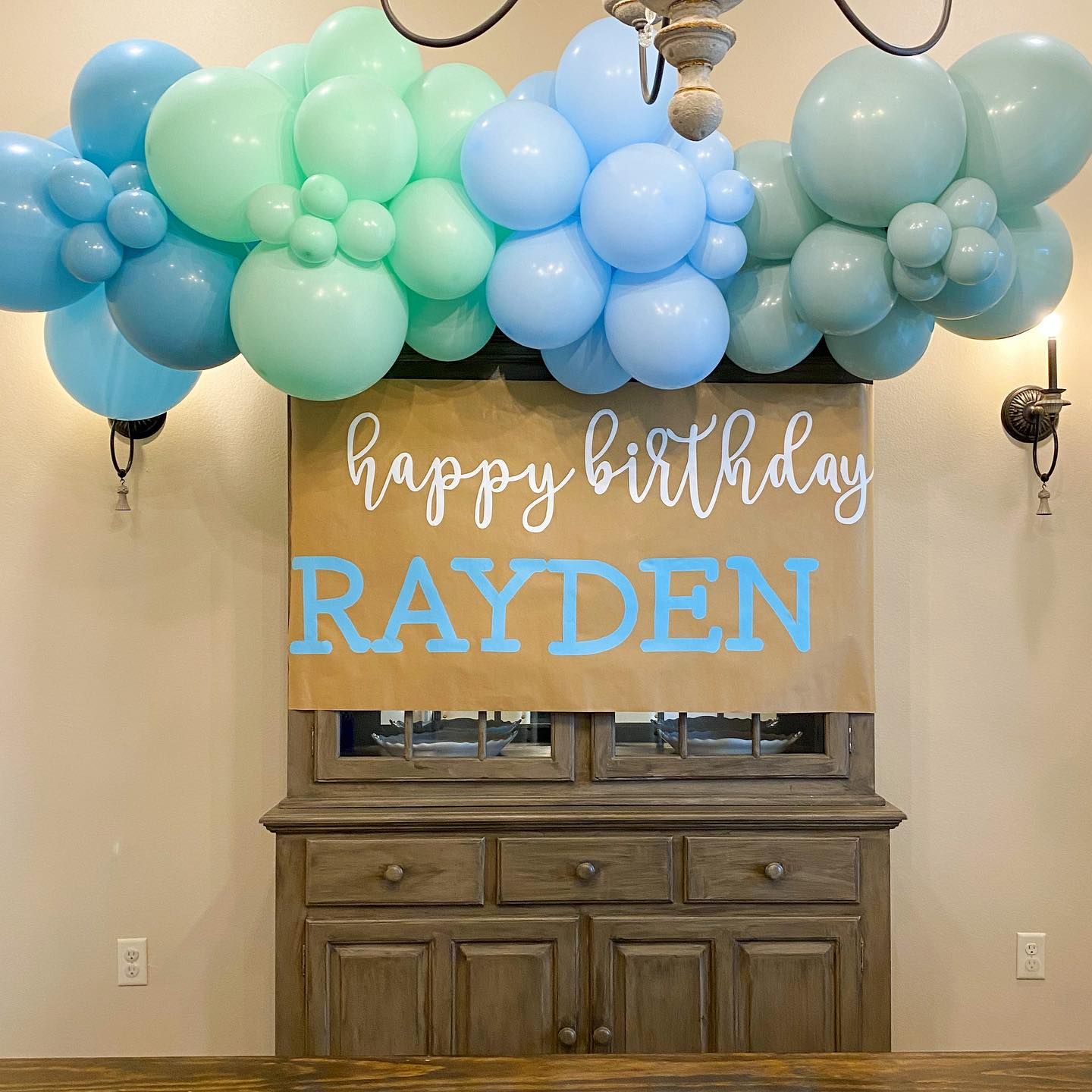 Birthday party decoration with blue and green balloons,