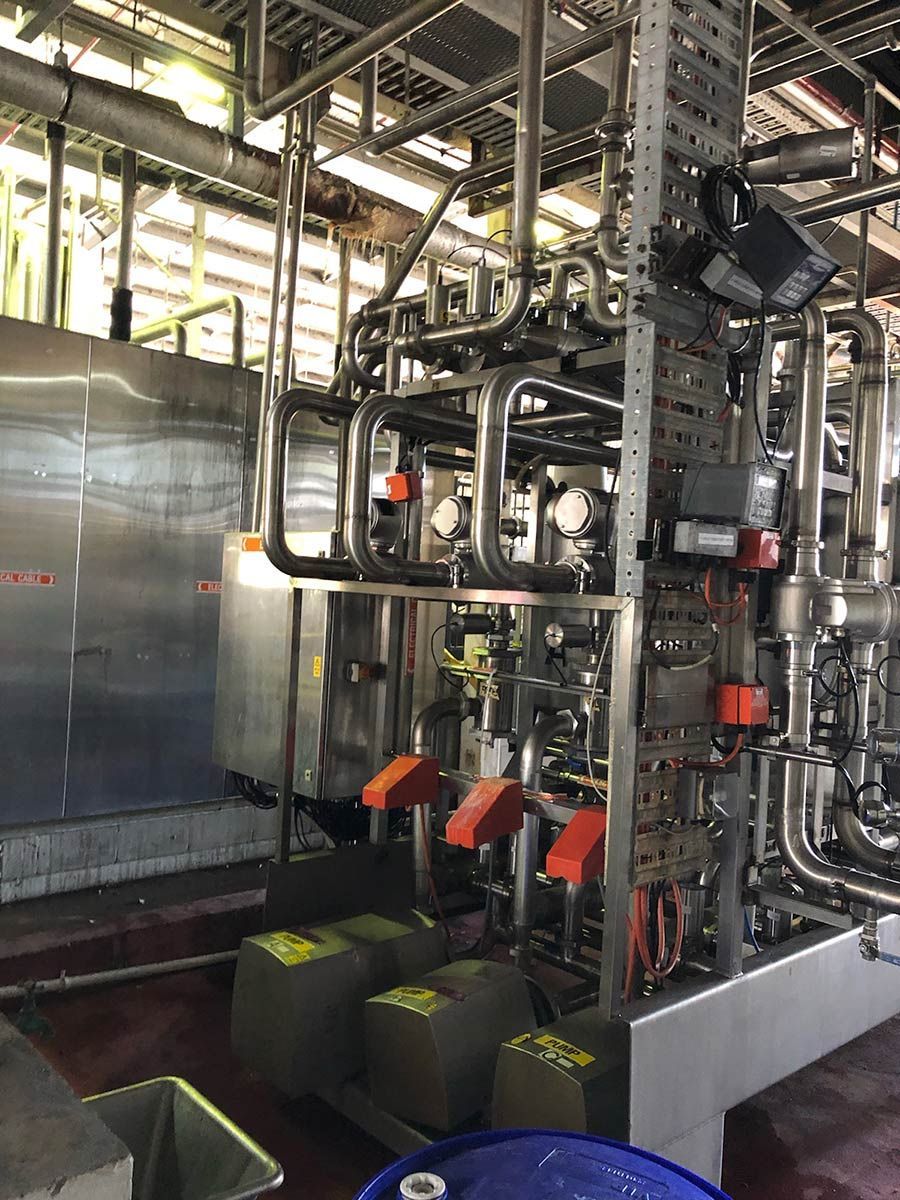 A Large Room Filled With Lots Of Pipes And Machinery — Hanby Welding & Engineering In Portsmith, QLD