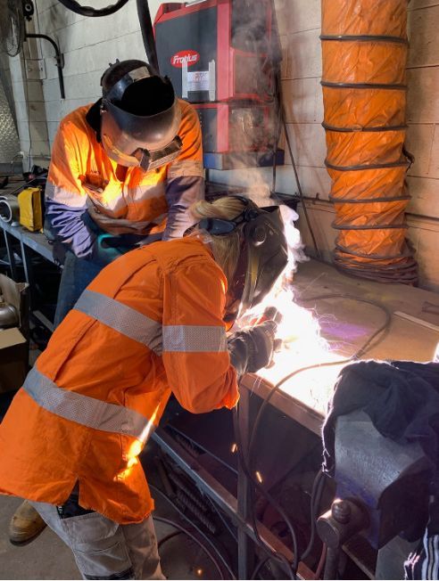 Two Person Is Wearing A Welding Mask And Working In A Piece Of Metal — Hanby Welding & Engineering In Portsmith, QLD