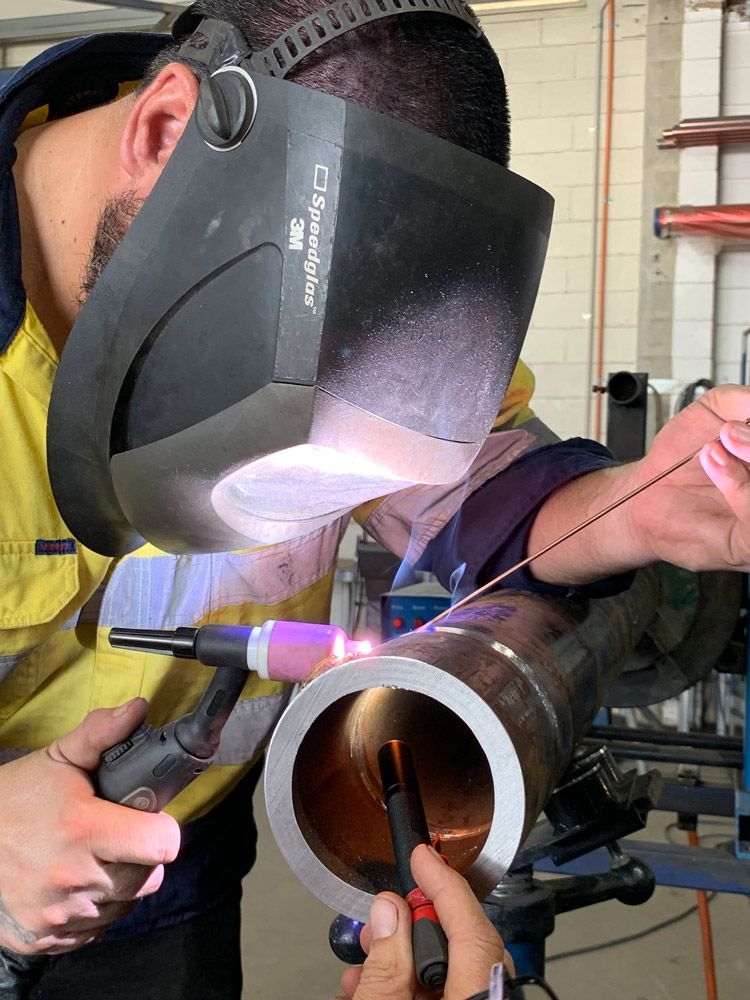 Man Welding Steel Pipe