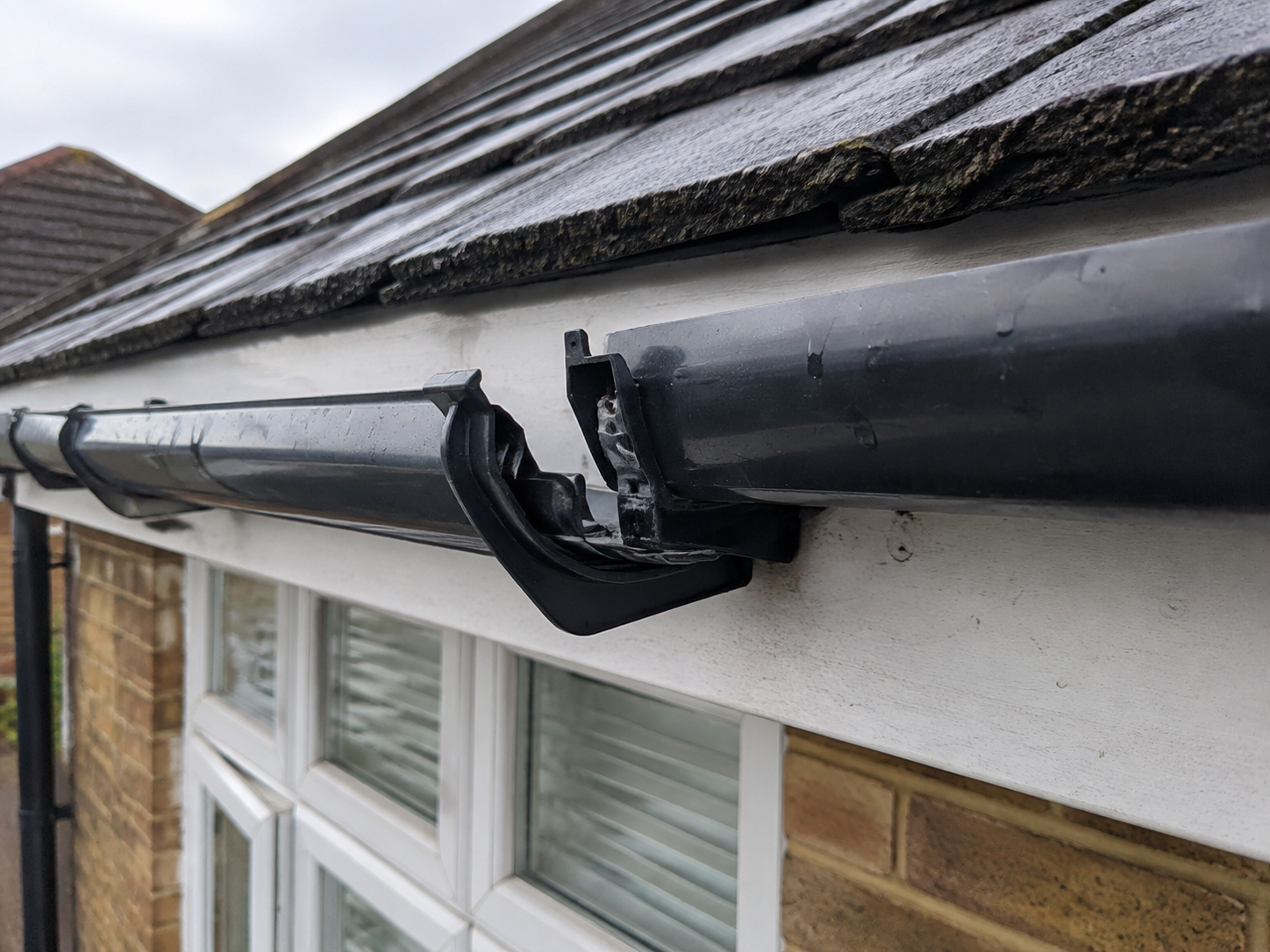 Loose gutter bracket causing black guttering to pull away from the fascia