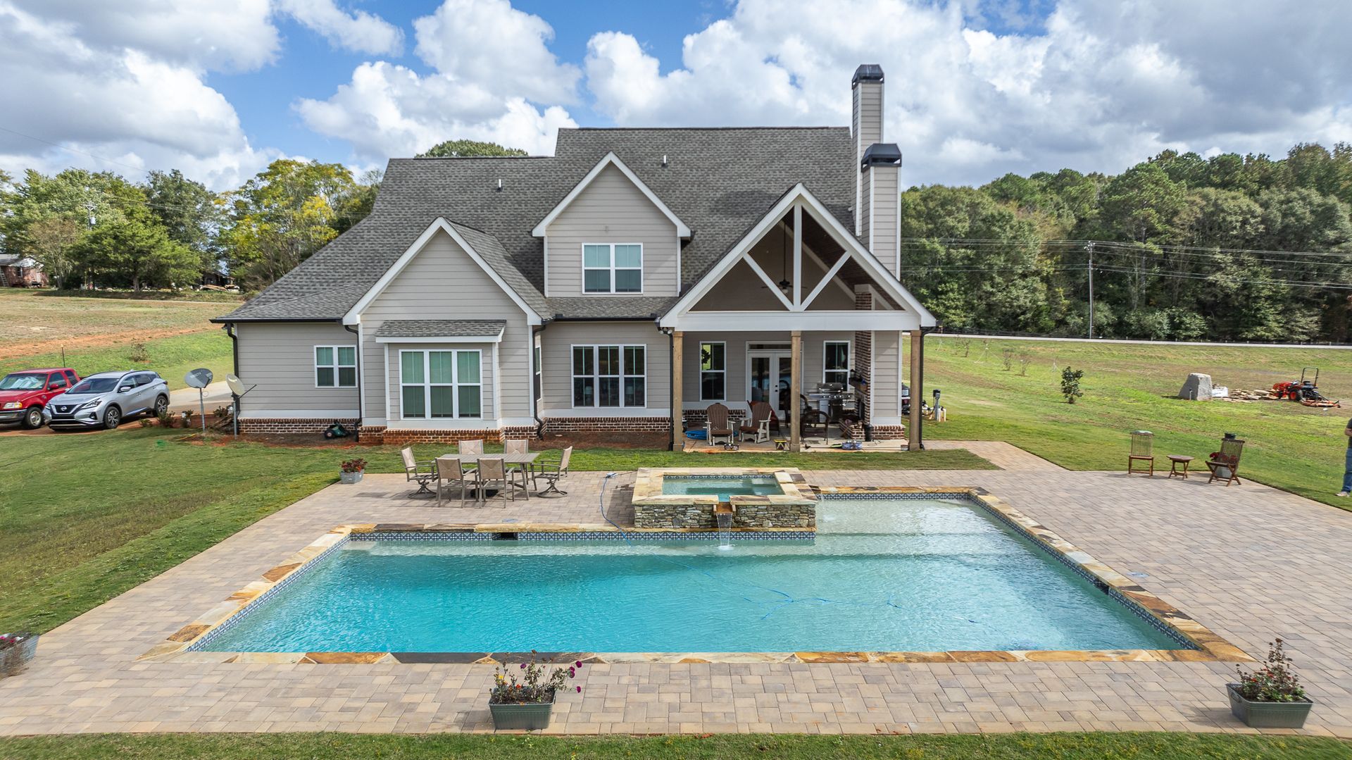 A large house with a large swimming pool in front of it.