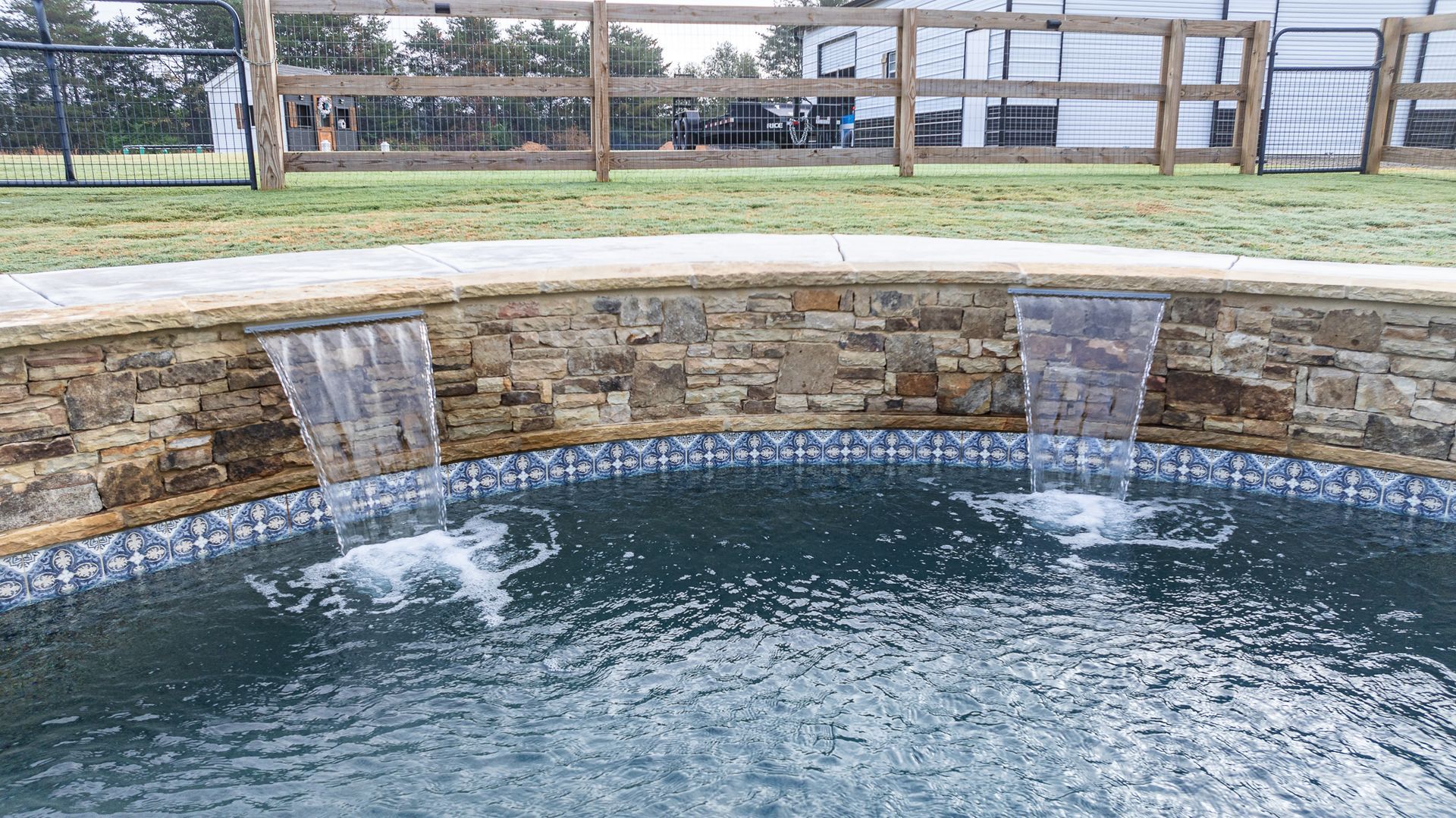 There is a waterfall in the middle of the pool.