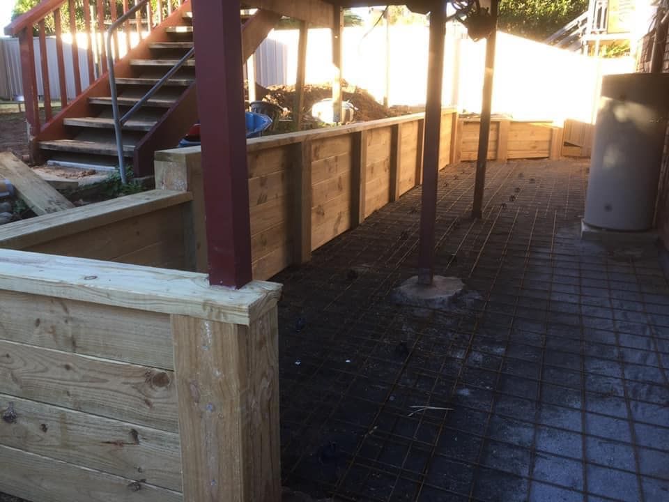 A Wooden Fence with Stairs in The Background — J’s Concreting & Carpentry in Kempsey, NSW