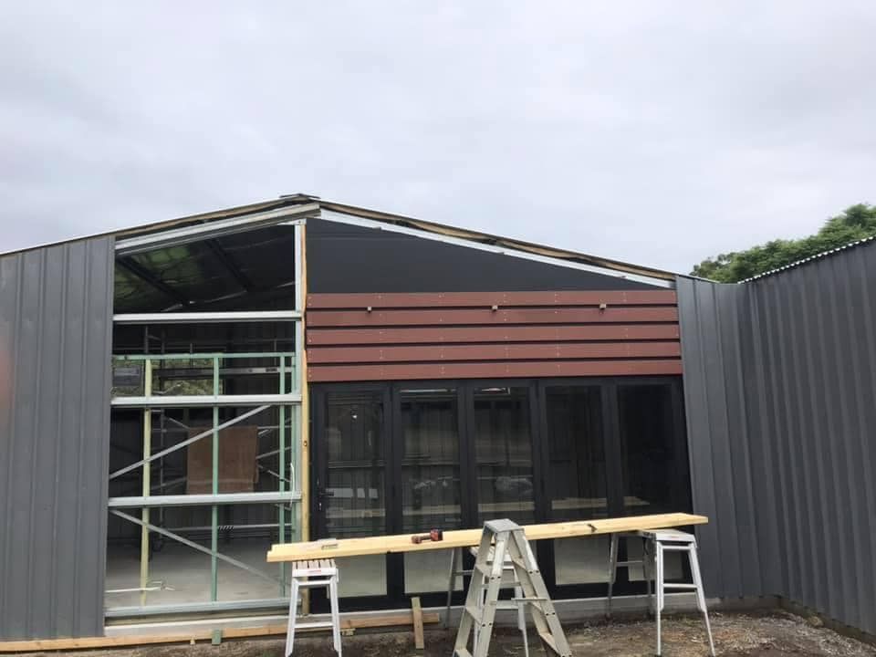 A Ladder Is Sitting in Front of A Building Under Construction — J’s Concreting & Carpentry in Kew, NSW