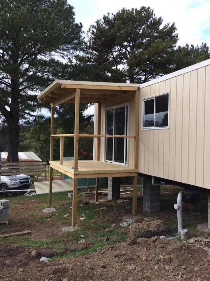 A Small House with A Porch and A Sliding Glass Door — J’s Concreting & Carpentry in Kew, NSW