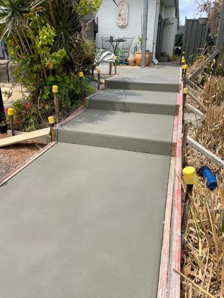 A Concrete Walkway Is Being Built in Front of A House — J’s Concreting & Carpentry in Kendall, NSW