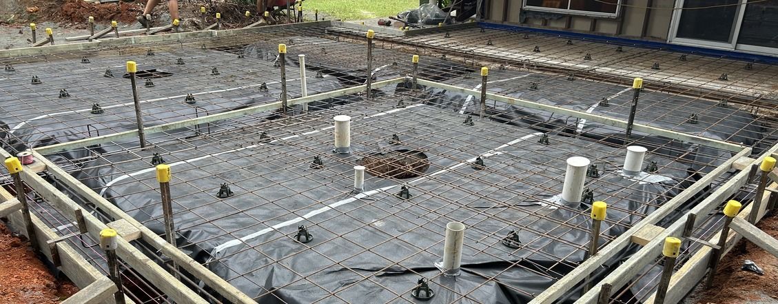 There Is a Large Swimming Pool in The Backyard of A House — J’s Concreting & Carpentry in Kew, NSW