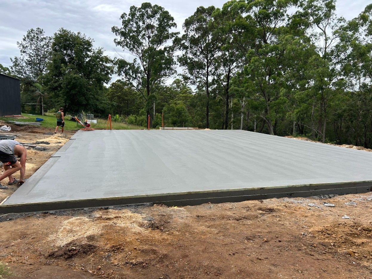 Large Concrete Slab Poured at A Wooded Construction Site — J’s Concreting & Carpentry in Kew, NSW