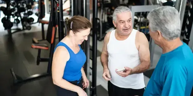 group of older adults conversing at the gym