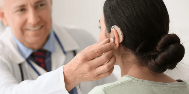 woman receiving hearing aid treatment for tinnitus