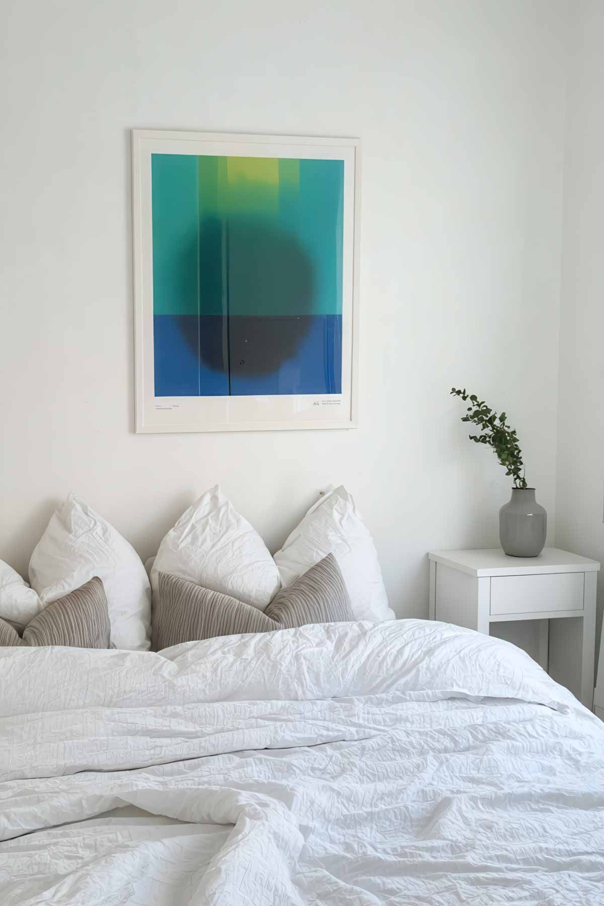 Minimalist white bedroom with bold art on the wall