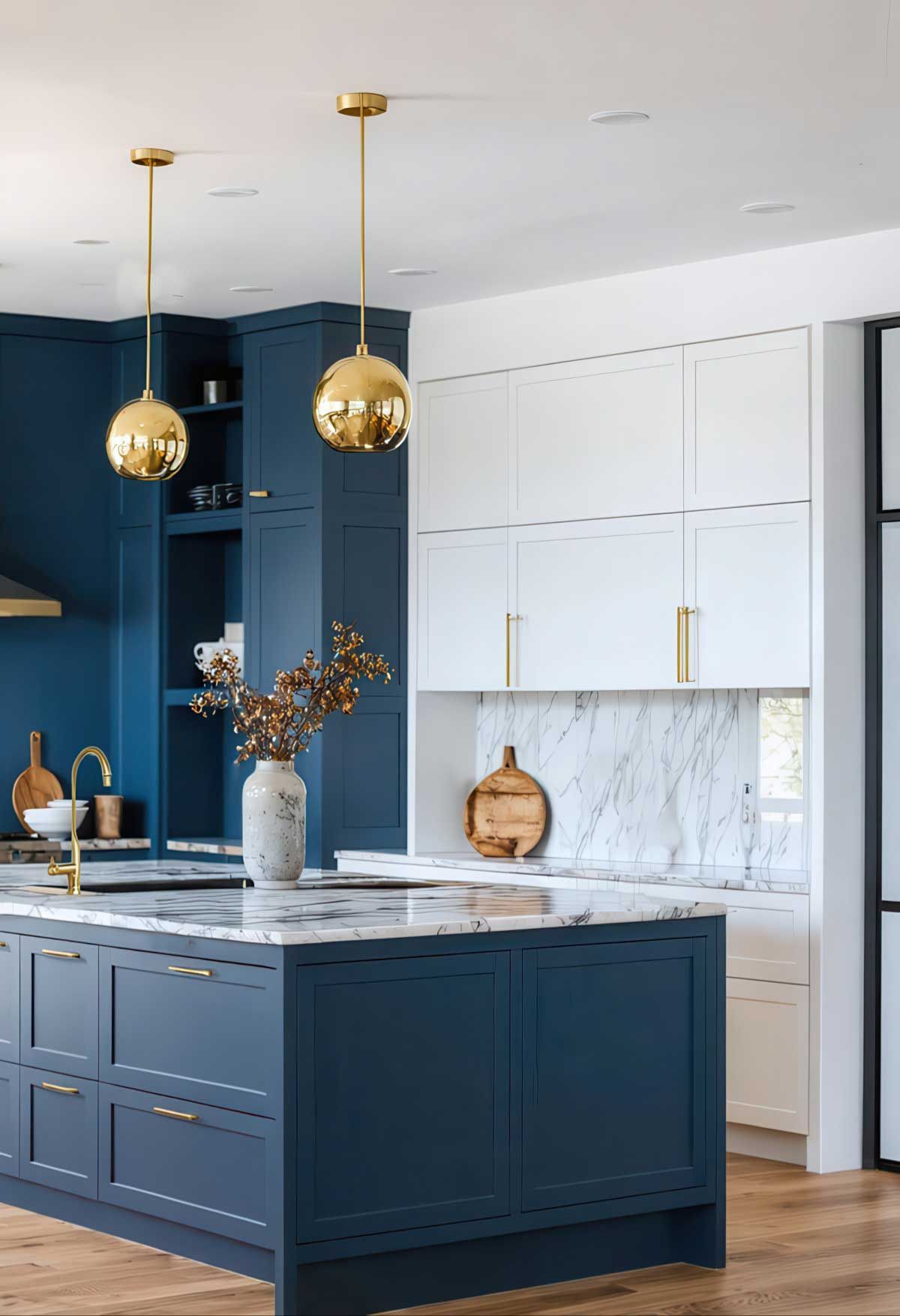 A kitchen with blue cabinets , white cabinets , and a large island showcasing the two tone cabinet