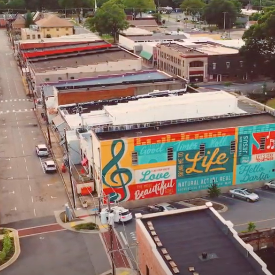 Searcy AR Criminal Lawyers An aerial view of a city with a mural on the side of a building that says life