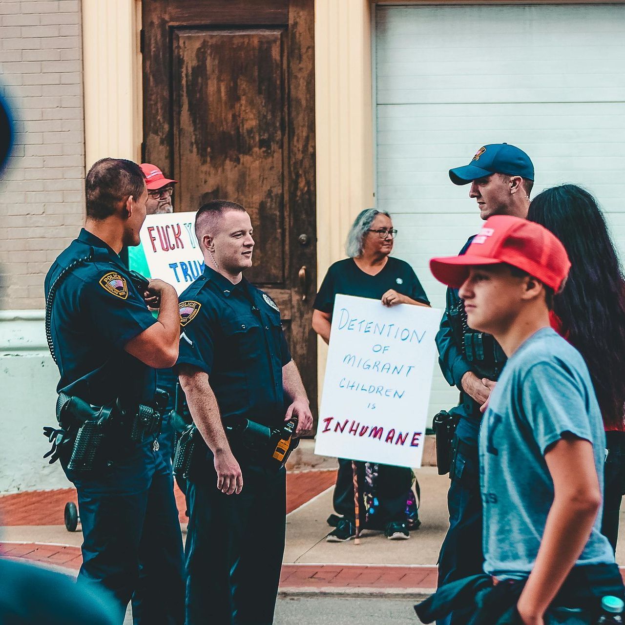 Immigration Offense Lawyers in AR A group of people holding signs one of which says inhumane