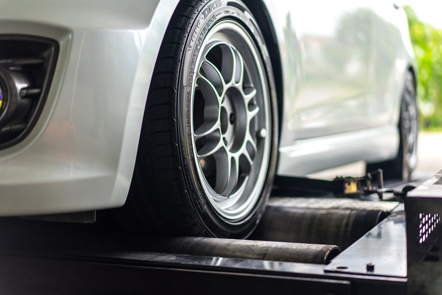 A White Car Is Being Tested on A Machine — Al's Mechanical & 4WD Grafton Repairs in Grafton, NSW