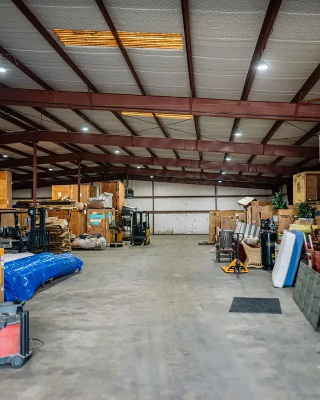 A large warehouse filled with lots of boxes and equipment.