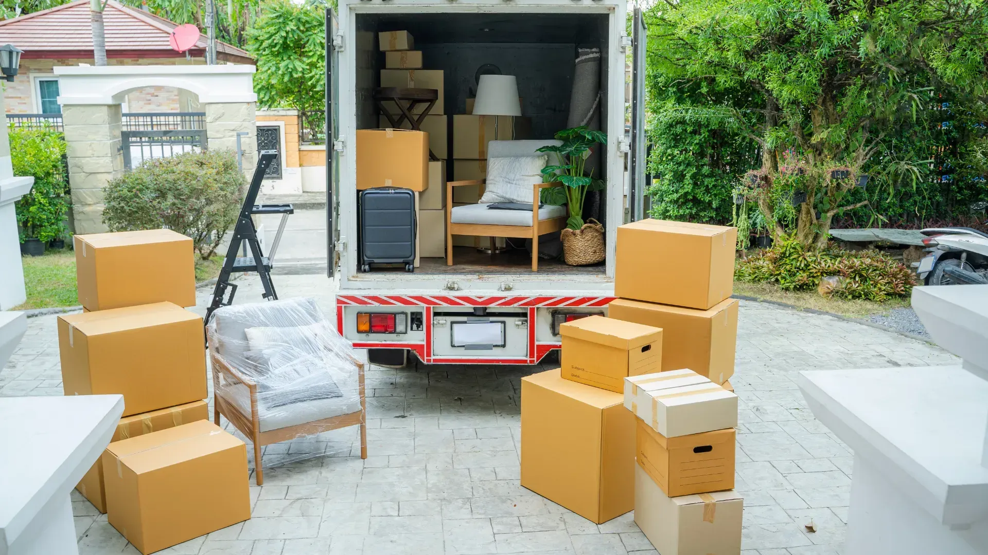 A moving truck is filled with boxes and furniture.
