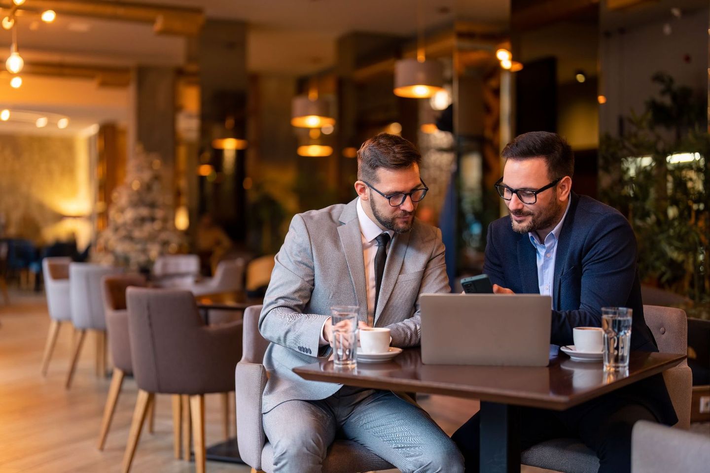 Two male business professionals having a digital marketing agency meeting in Adelaide with Assurance Digital. 