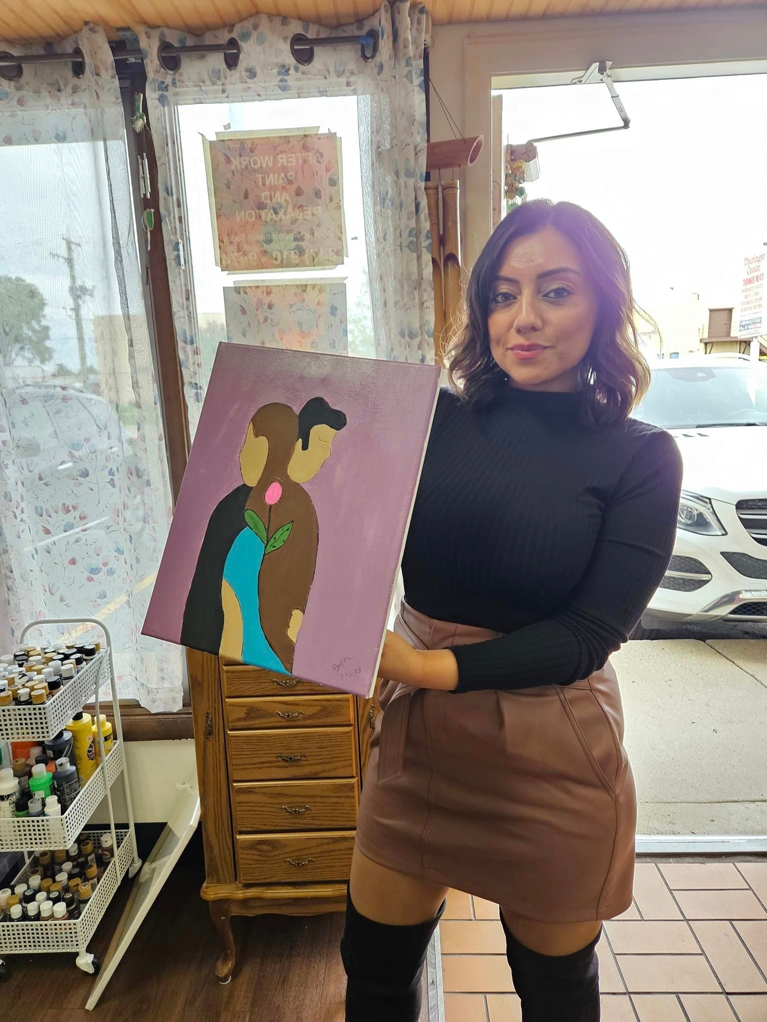 man and woman painting with flower