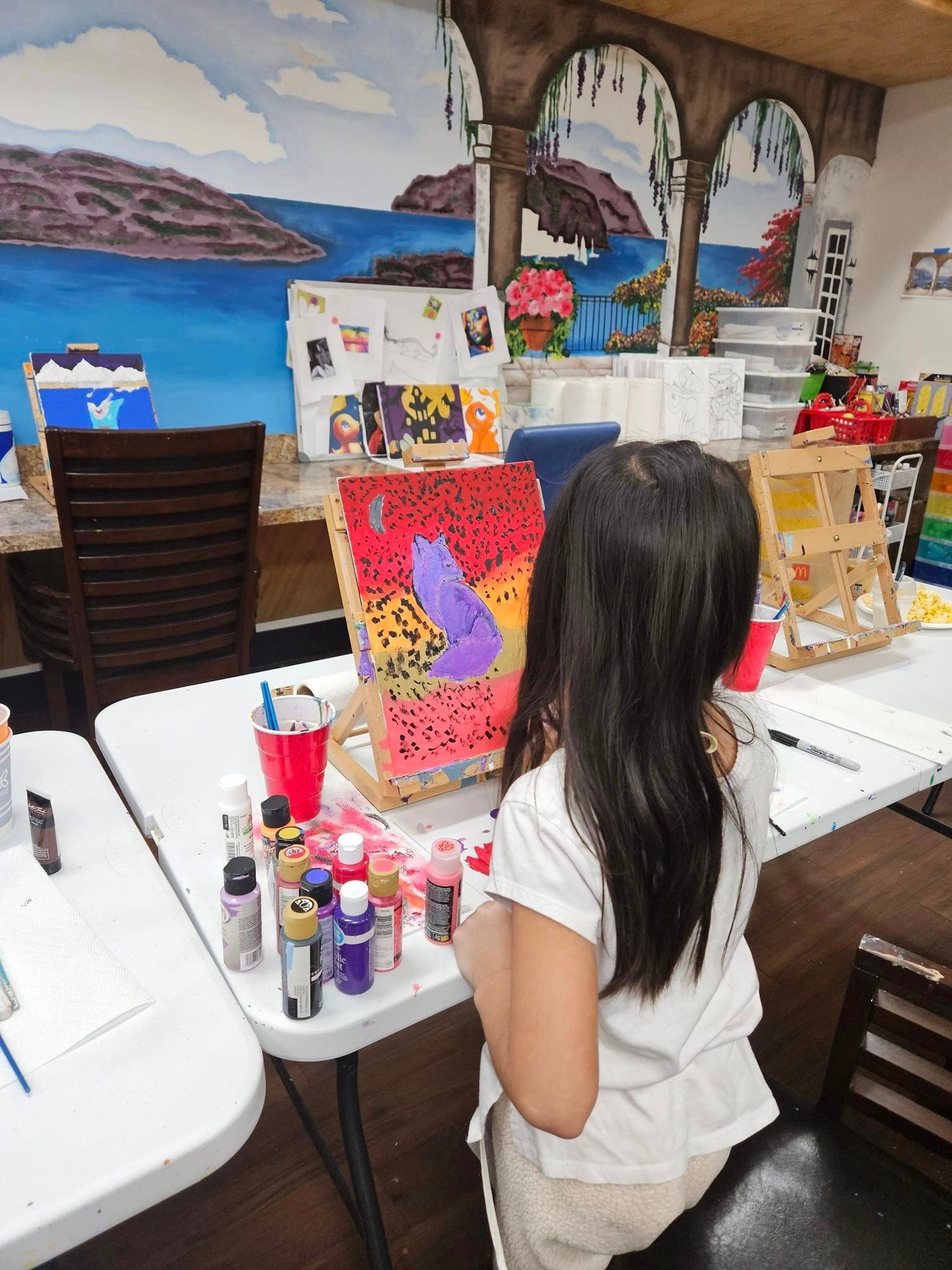a girl painting her purple wolf