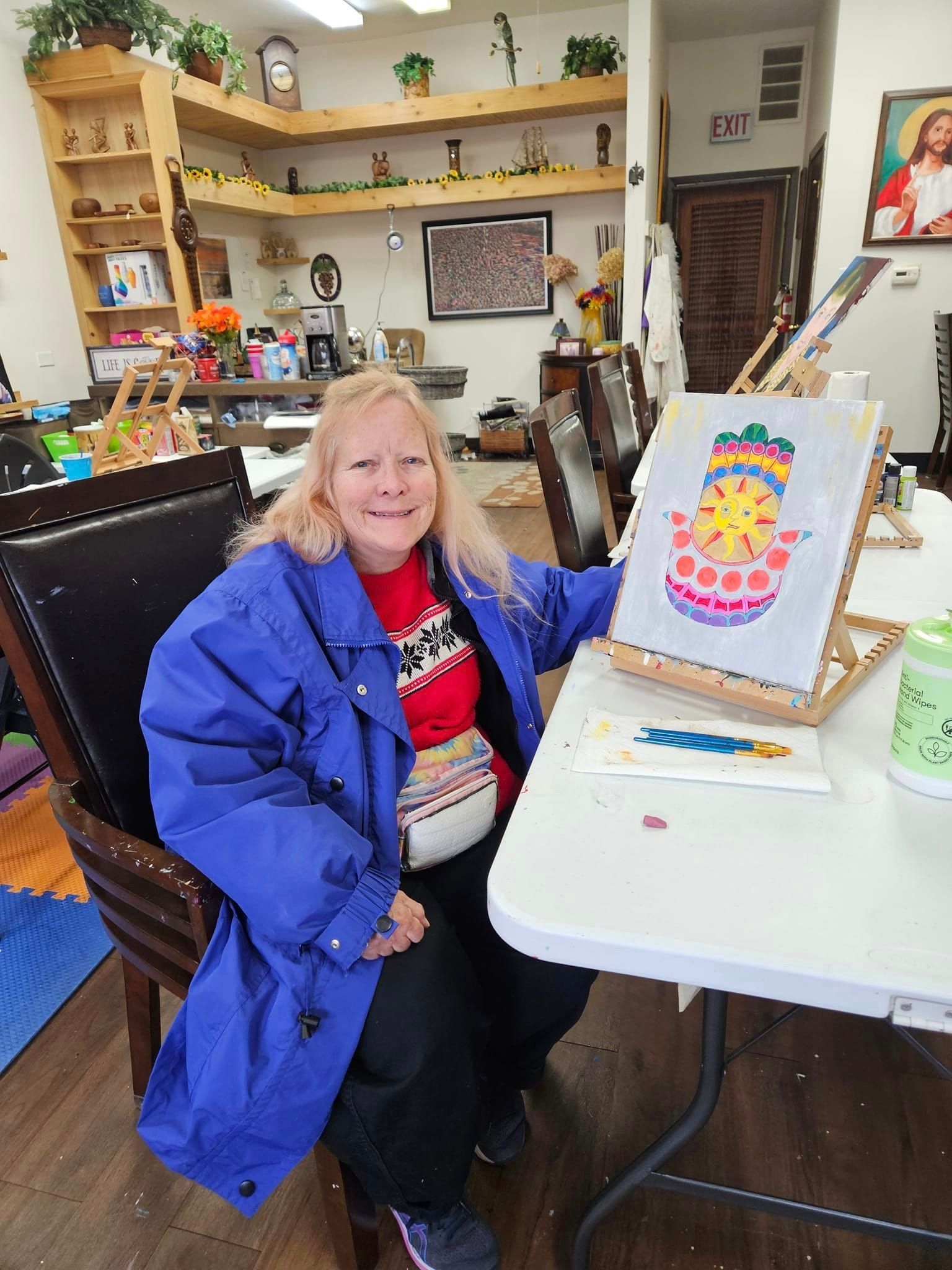 a lady and her colorful paiting