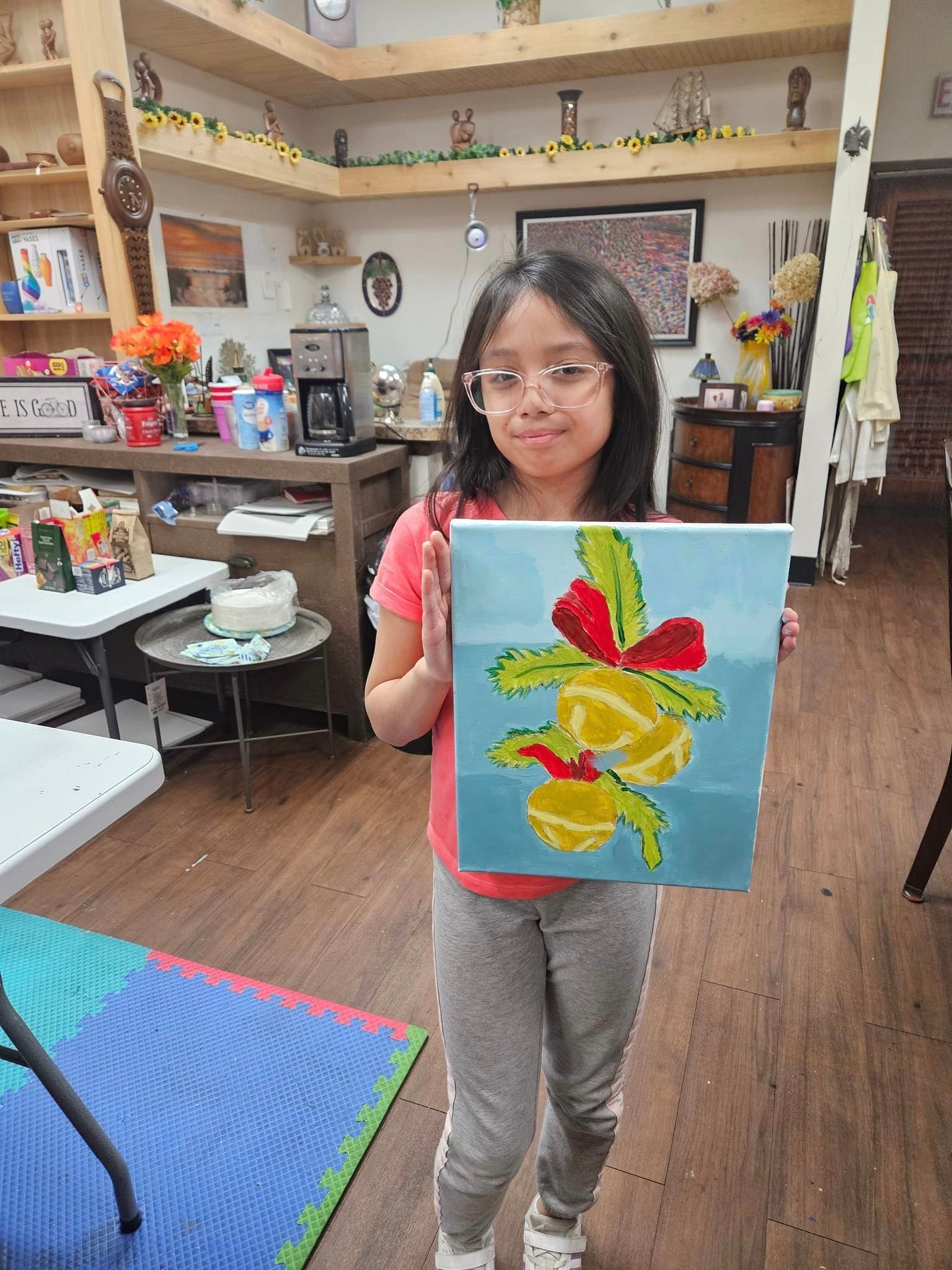 a girl in glasses and her painting