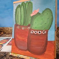 A painting of two cactus in pots on an easel.