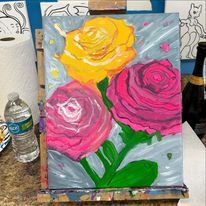 A painting of three roses on an easel on a table.