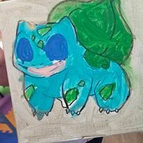 A person is holding a painting of a pokemon on a piece of paper.