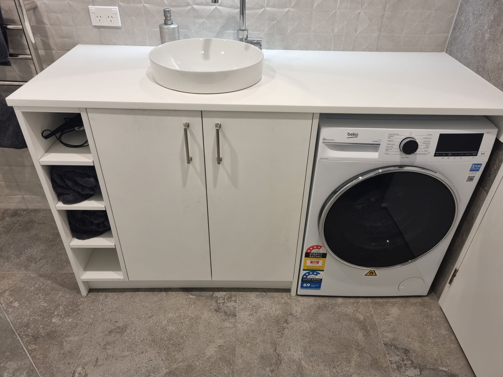 Vanity and storage detail in an integrated bathroom and laundry