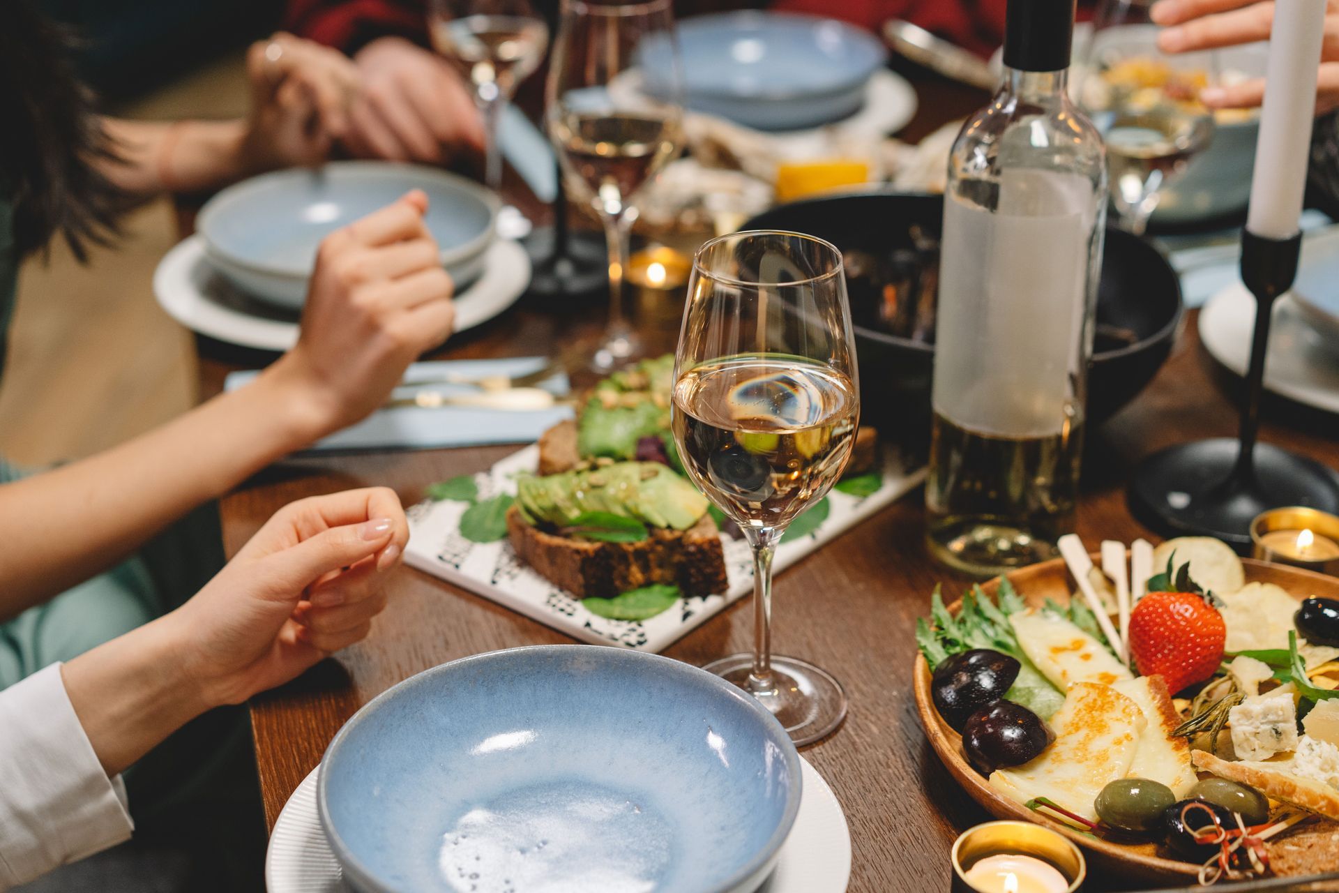 dinner party image with a set table with food and wine