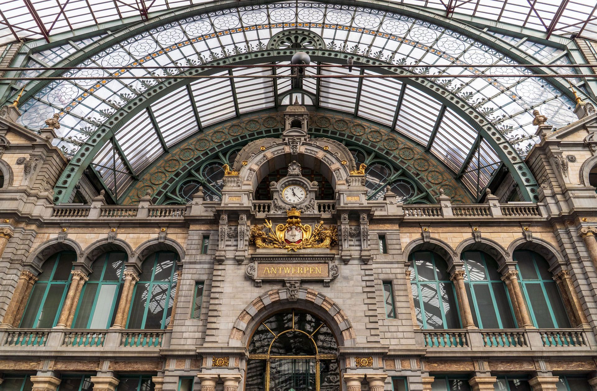 Ornate historic building facade with arched windows and a large glass dome ceiling