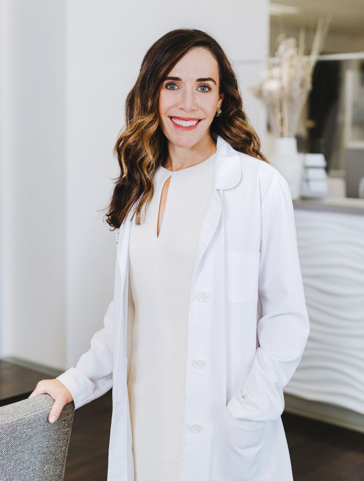 a portrait of Dr. Jill Javahery, Board-Certified Dermatologist wearing a white doctor's coat