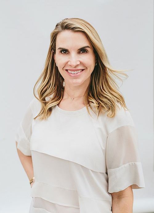 a portrait of Dr. Nancy Samolitis, Board-Certified Dermatologist wearing a white blouse