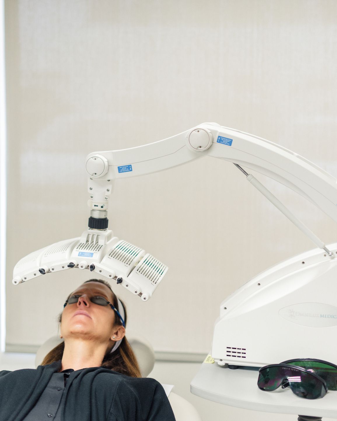 patient under blue light device for photodynamic therapy treatment for skin