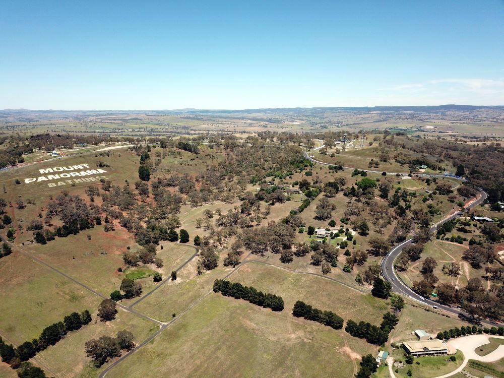 An Aerial View of a Lush Green Field With Trees and a Road — Prime Built in Hill Top, NSW