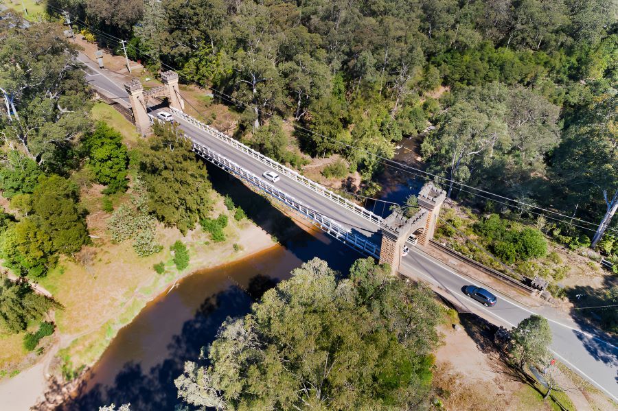 An Aerial View of a Bridge Over a River Surrounded by Trees — Prime Built in Moss Vale, NSW
