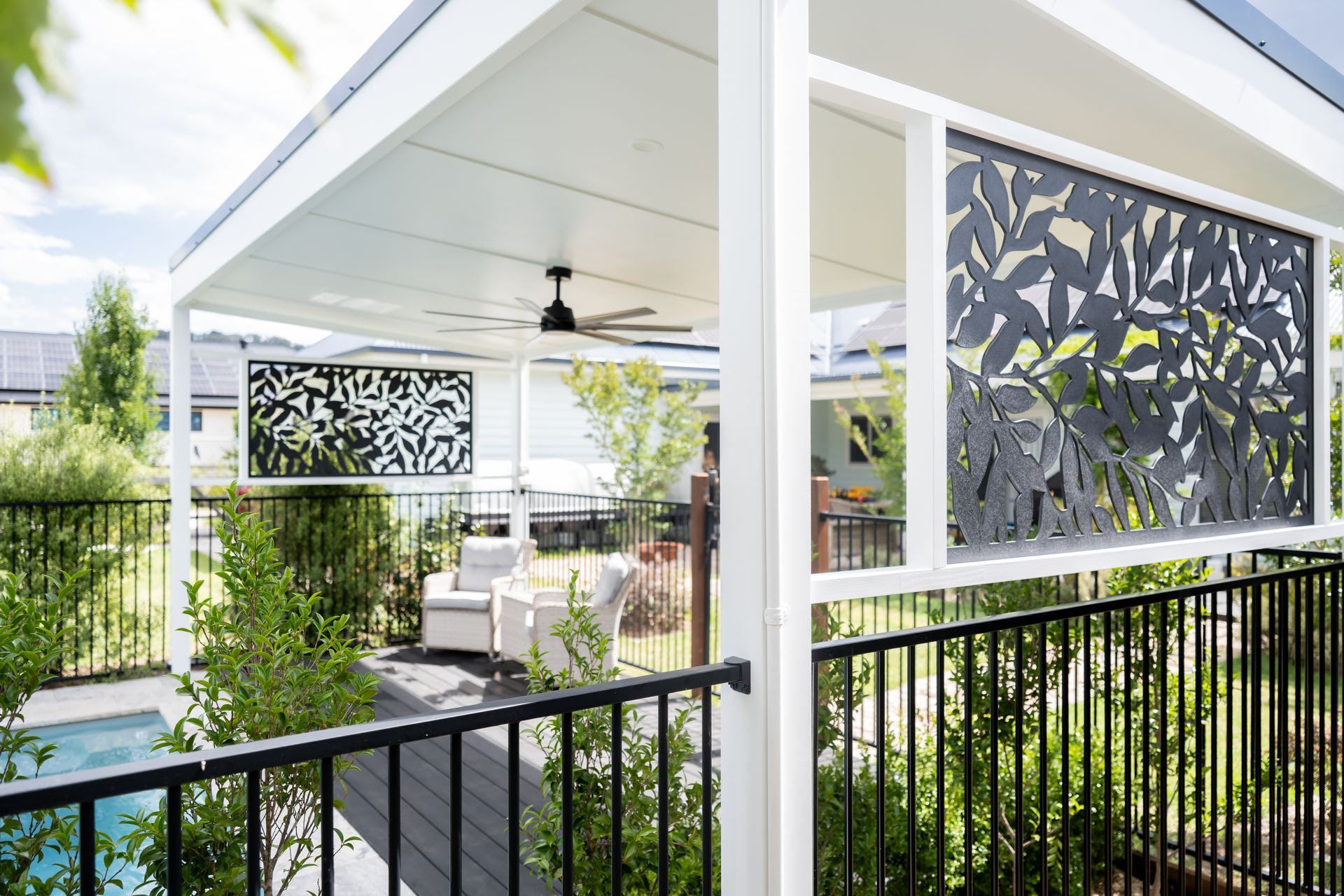 Modern Patio With White Pergola, Black Railing, and Patterned Privacy Screens — Prime Built in Bowral, NSW