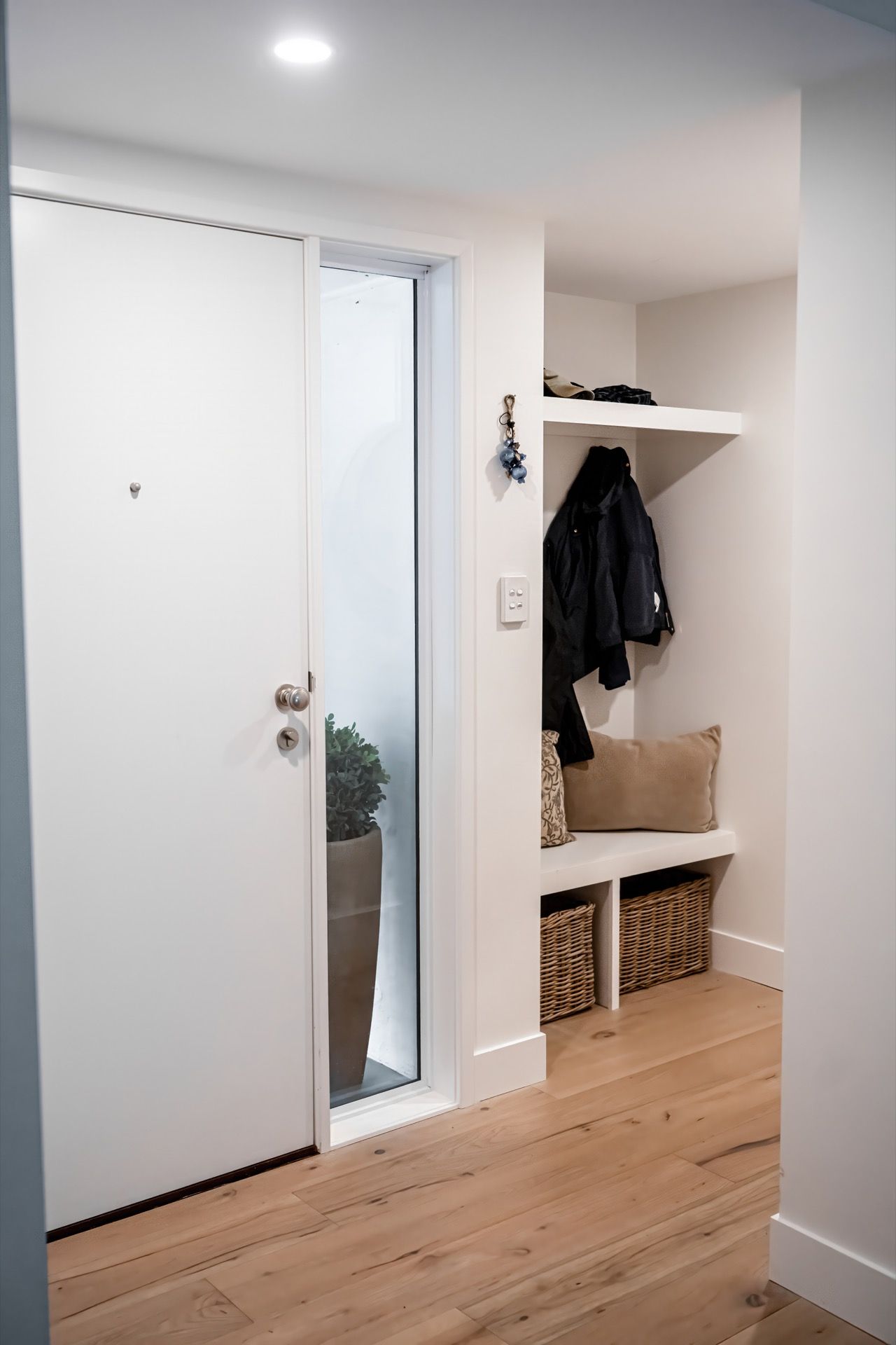 Front Entryway With White Walls, Light Wood Floor, and Open Closet — Prime Built in Bowral, NSW