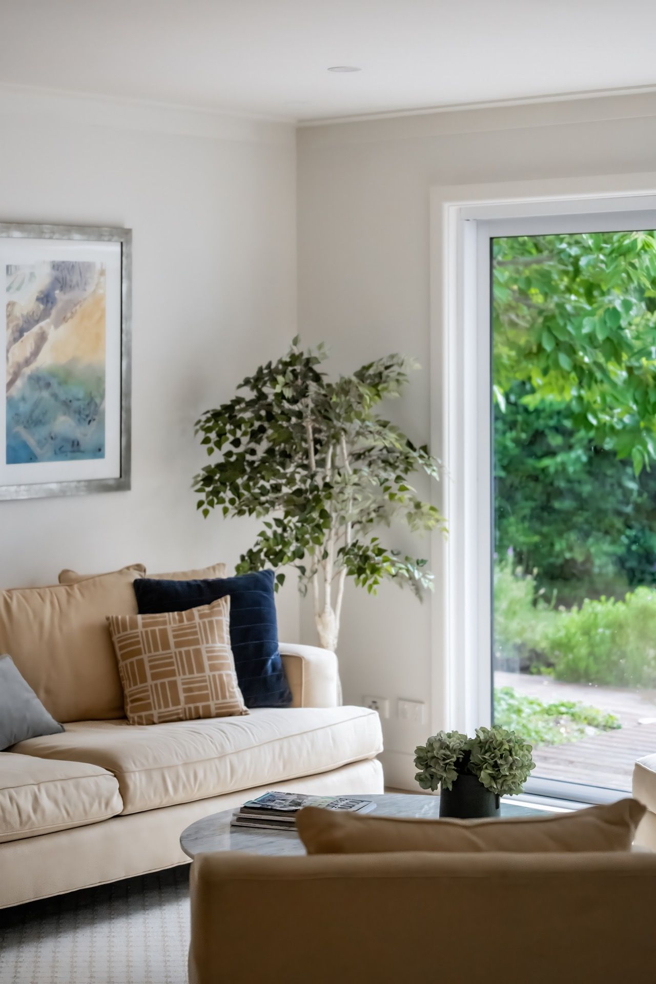 Bright Living Room With Beige Sofa, Plants, and a Large Glass Door — Prime Built in Bowral, NSW