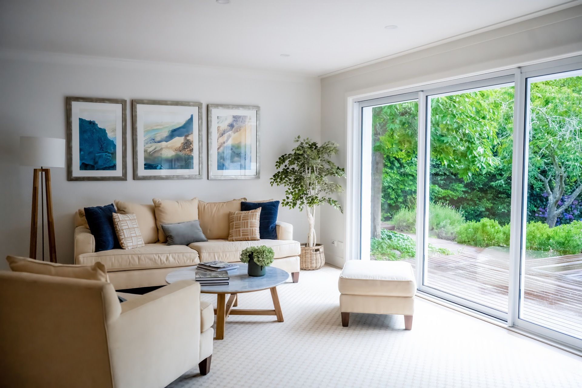 Bright Living Room With Beige Sofa, Artwork, and Sliding Glass Doors — Prime Built in Bowral, NSW
