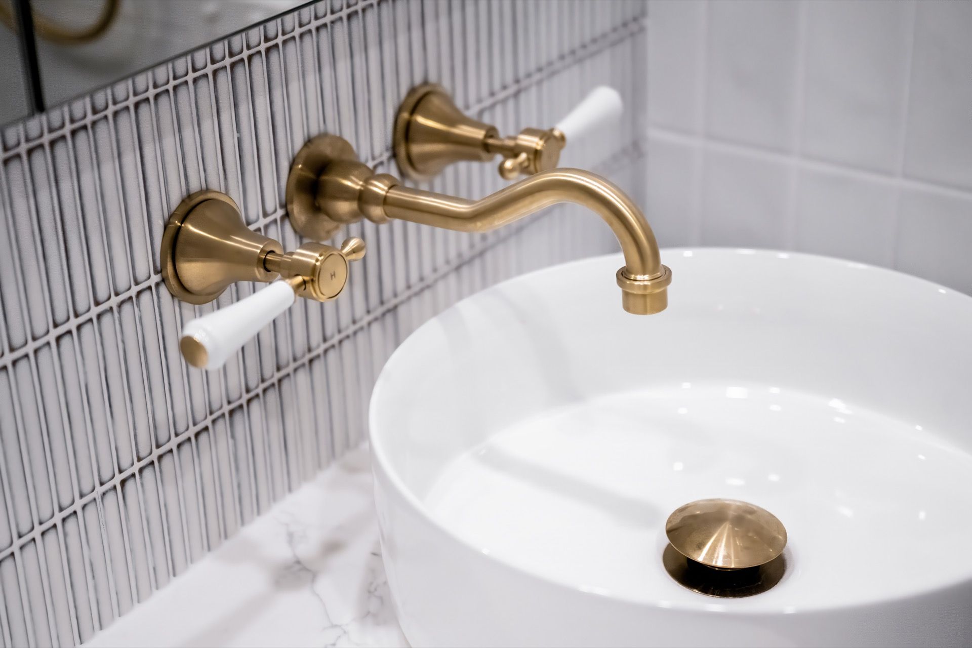 Gold Wall-mounted Faucet Over White Vessel Sink — Prime Built in Bowral, NSW