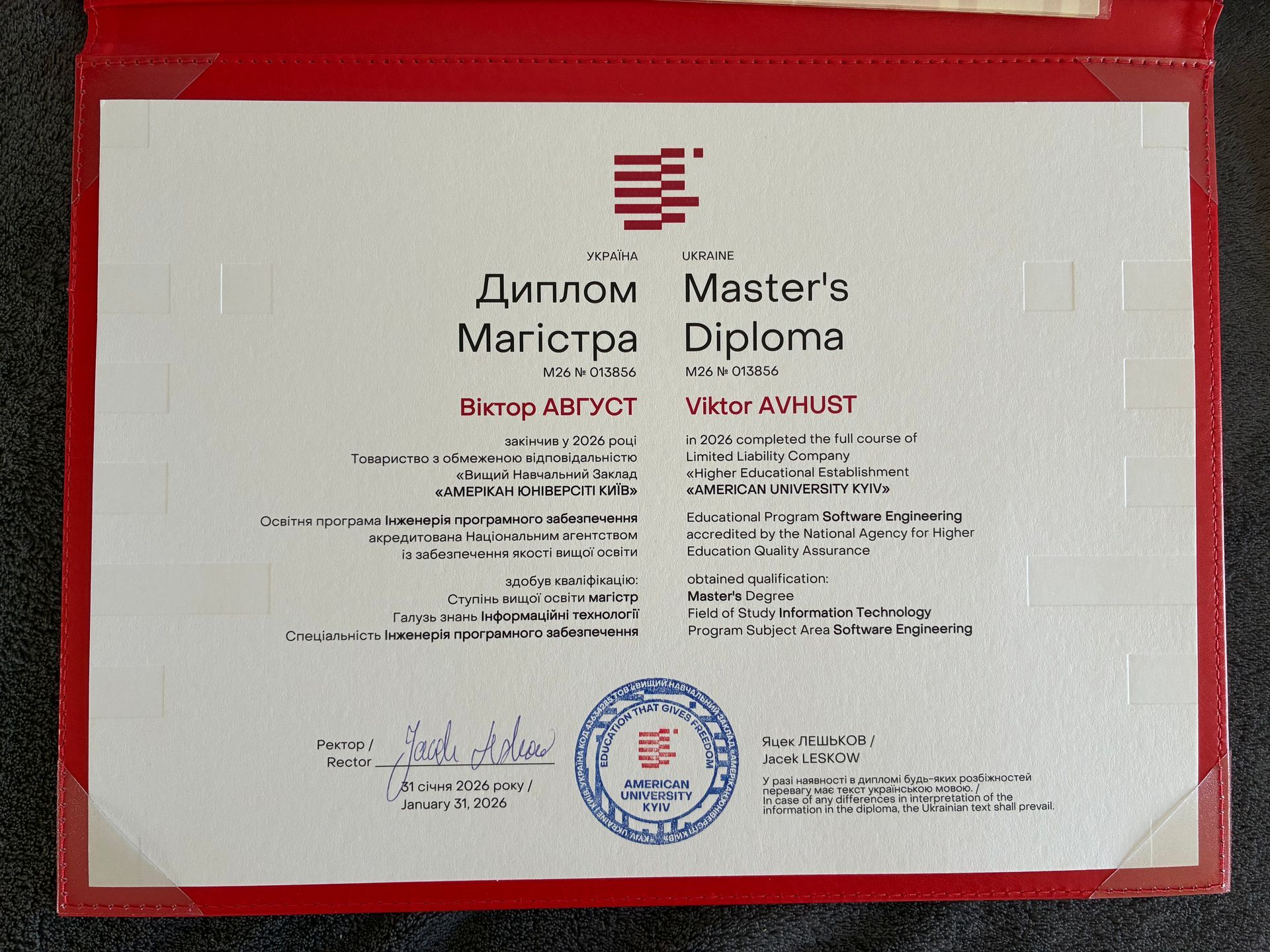 Master's diploma certificate with Ukrainian and English text, blue seal, and signatures on a white background