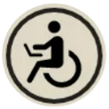 Accessible restroom symbol in black on a beige circular sign